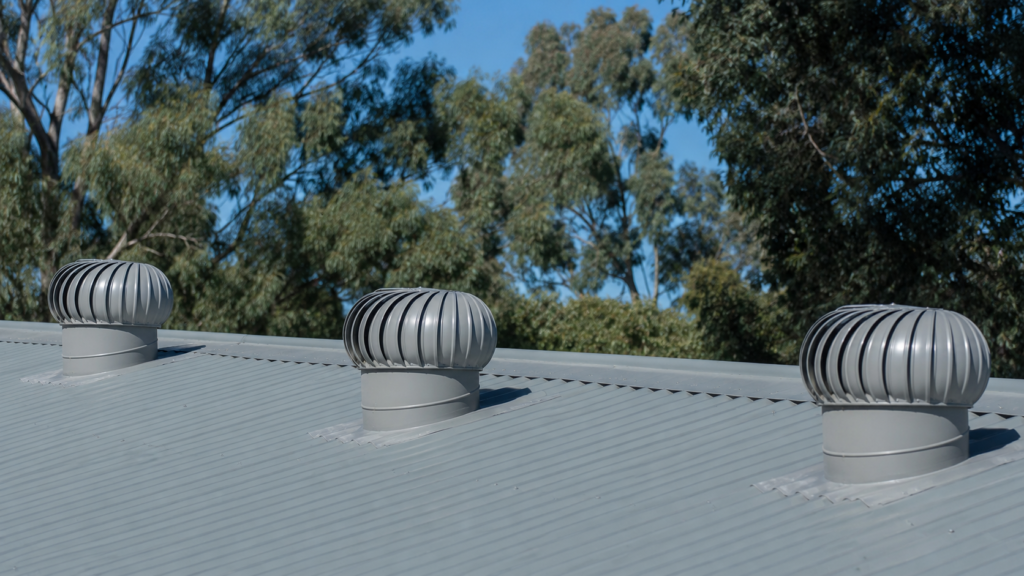 3 Whirlybirds on a grey commercial roof